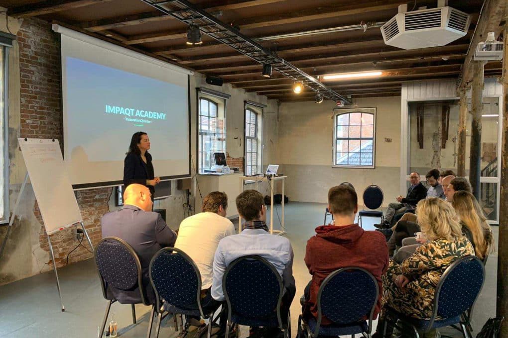 A woman giving a presentation to a group of people.